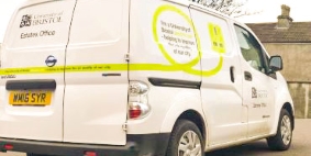 Image showing the rear quarter of our Print Services Electric Delivery van displaying the liveried side graphics of a lime green plug to illustrate the environmental impact